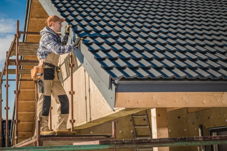 A roofer carefully inspecting the newly installed ceramic roof.