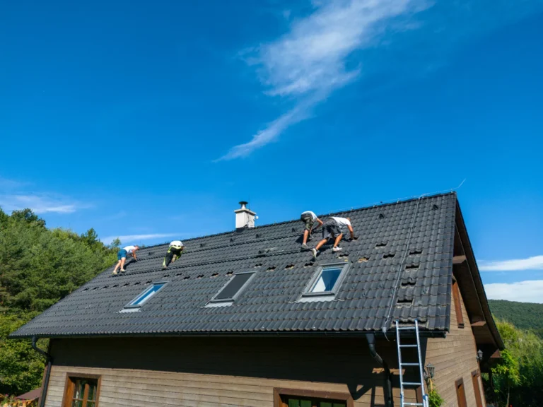 Men working on the roof finishing the ceramic tile type roof.